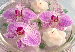 Floating orchid flowers and candles